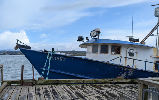 A fishing ship named Defiant with Warf at the helm.